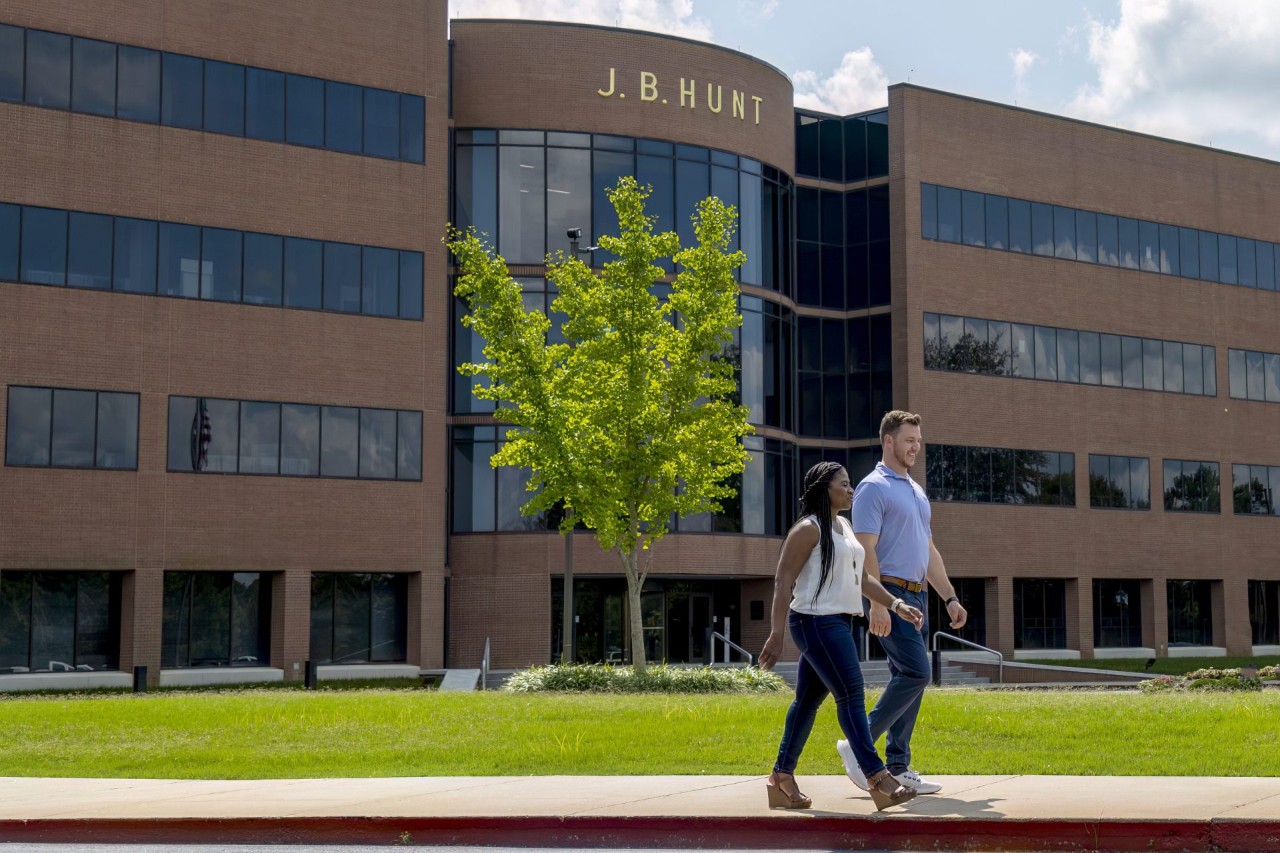 Two J.B. Hunt employees walking outside of the corporate campus.