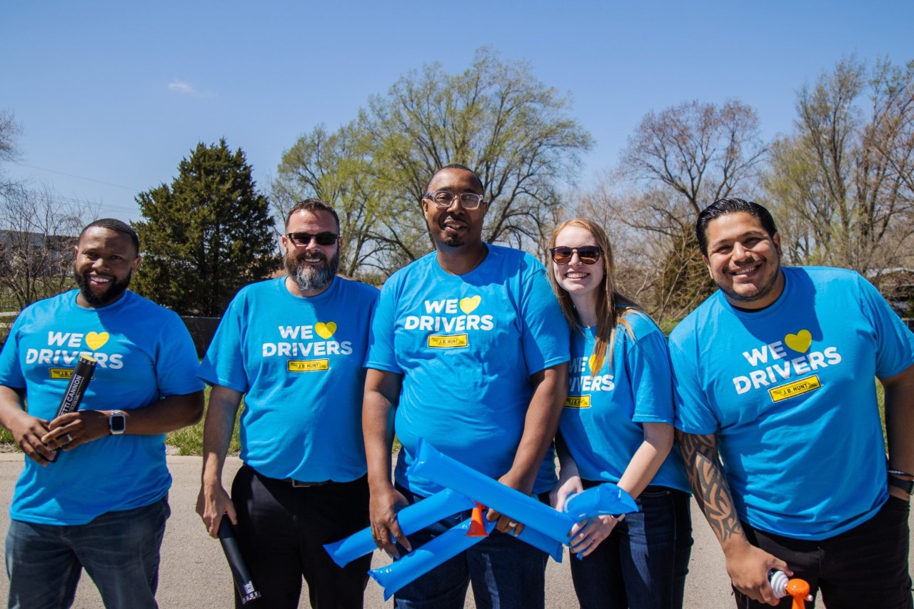 5 J.B. Hunt employees wearing "We Love Drivers" T-shirts.
