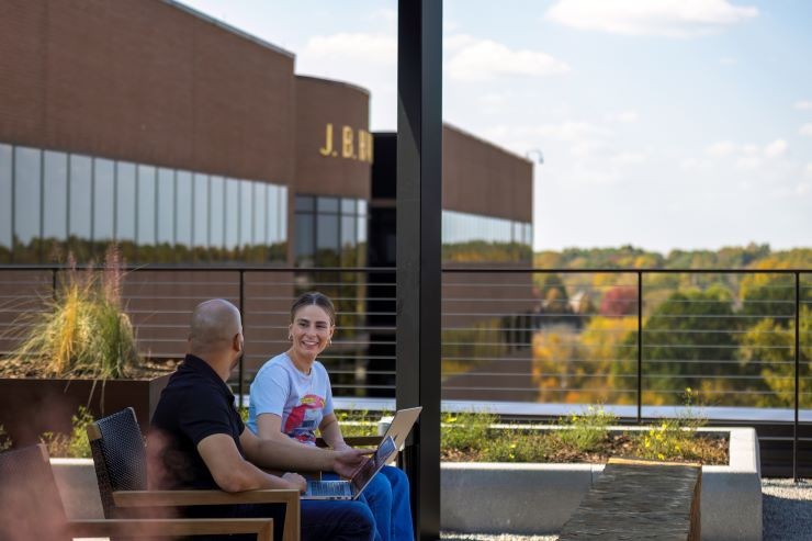 Two J.B. Hunt employees having a meeting on the J.B. Hunt corporate campus rooftop