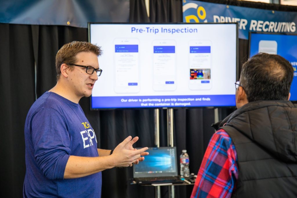 A J.B. Hunt employee talking to a person at an expo.