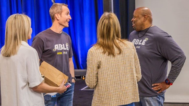 ABLE ERG members and J.B. Hunt employees engage in conversation during the ABLE launch event, fostering community and inclusion.