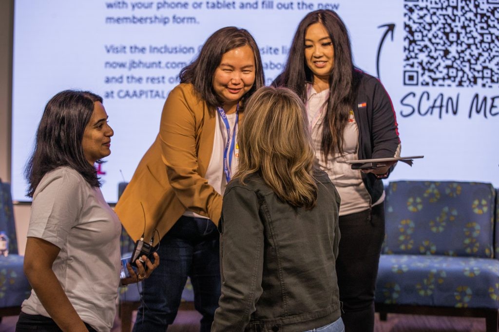 J.B. Hunt employees shaking hands at a CAAPITAL ERG event.