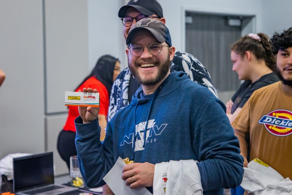 A J.B. Hunt employee smiling at a CAAPITAL ERG event.
