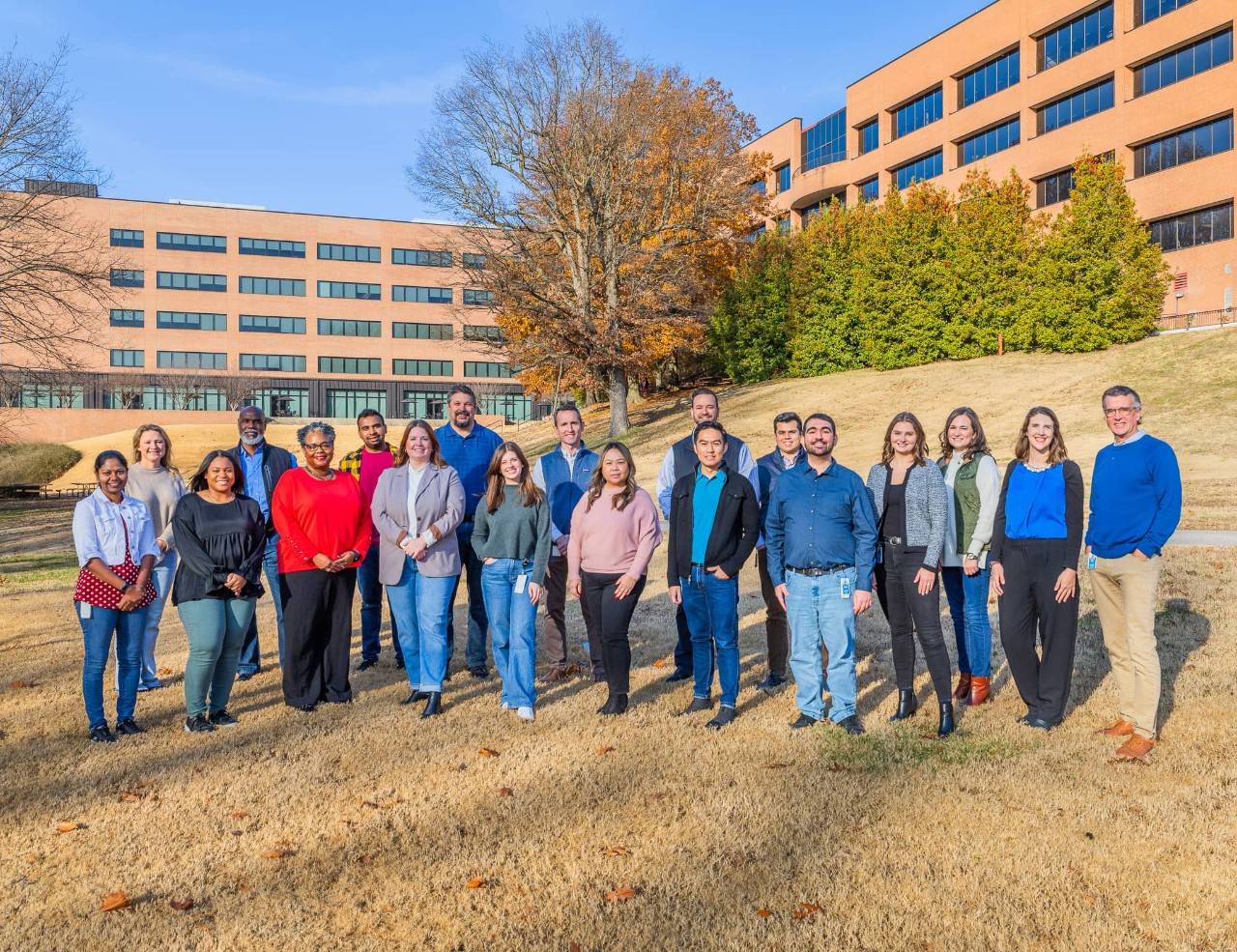 Members from all J.B. Hunt employee resource groups standing outside of the J.B. Hunt corporate campus posing for a photo.