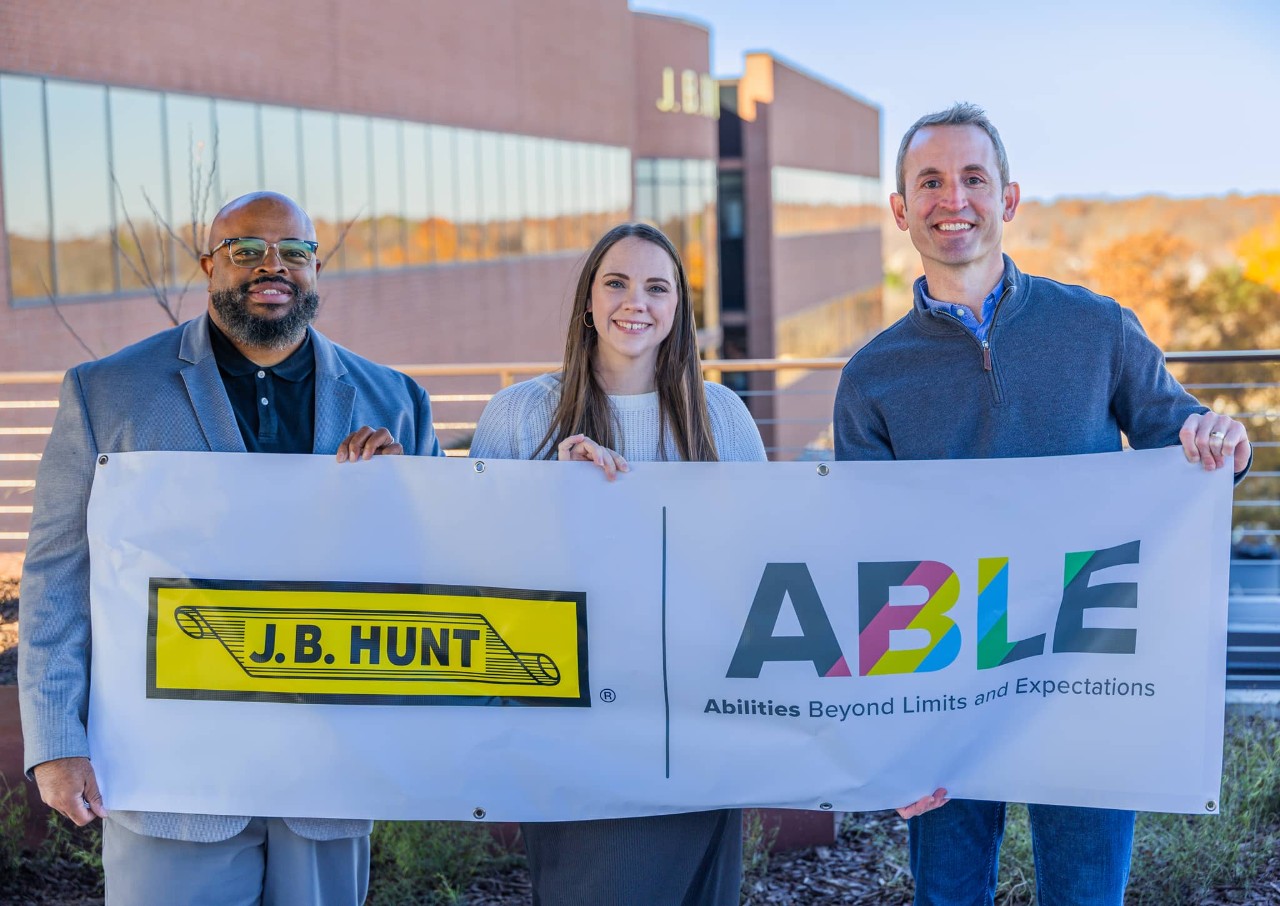Members of the employee resource groups, ABLE, holding a banner for ABLE. 