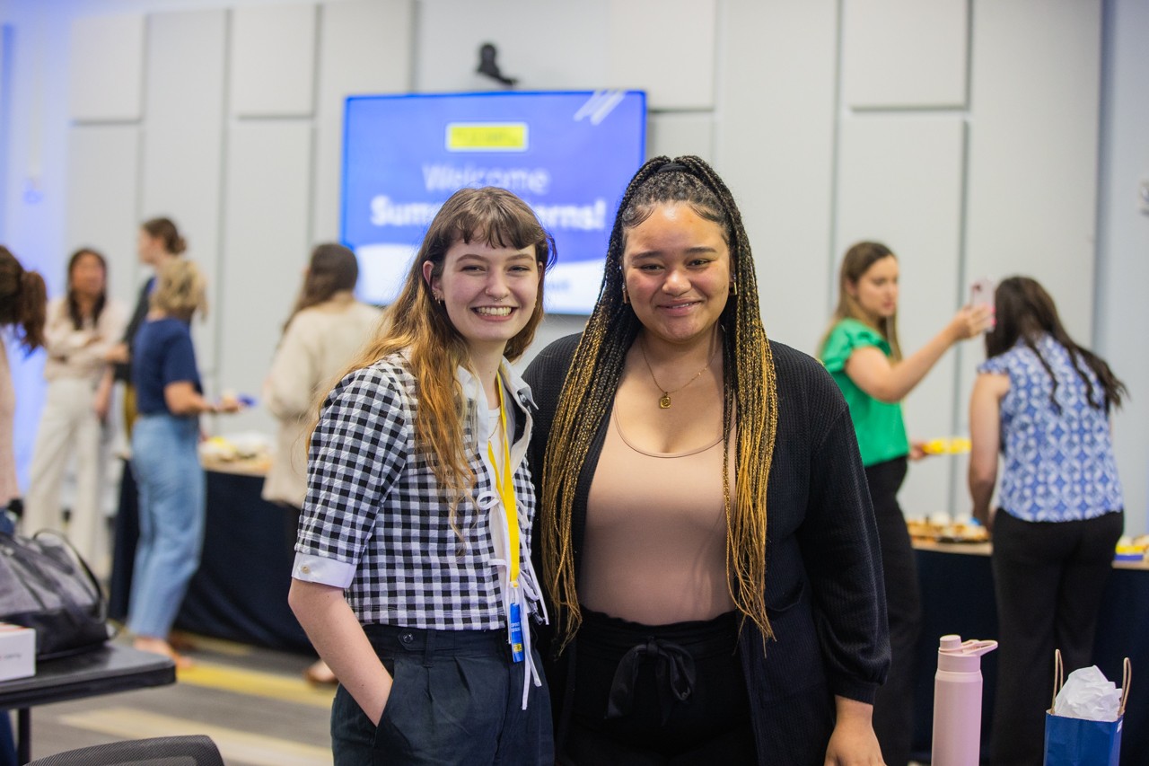 Two interns posing for a photo at a J.B. Hunt summer intern event.