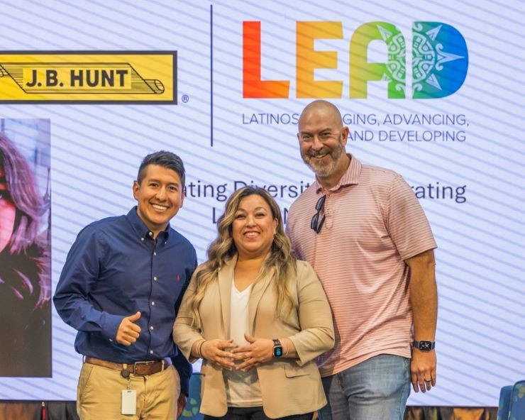 Three members of LEAD posing for a photo at an event