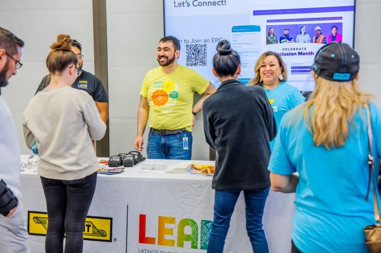 J.B. Hunt employees speaking to LEAD members at an ERG event booth.
