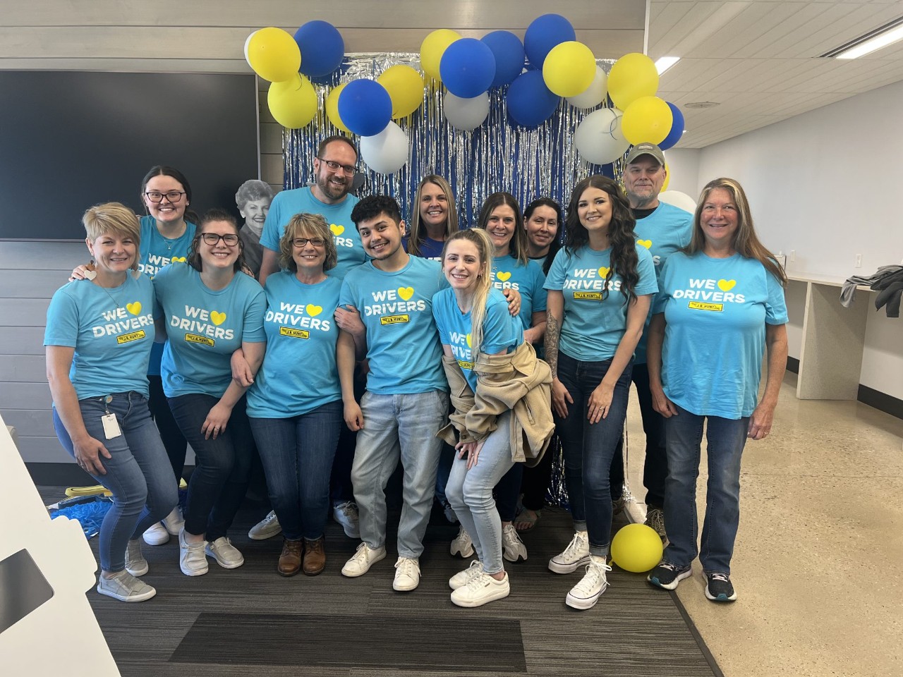 group of J.B. Hunt employees smiling in front of balloons and streamers