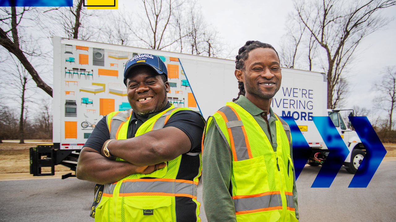 Warehouse employees(Salomon and Julian) posing for a photo in front of a J.B. Hunt box truck.