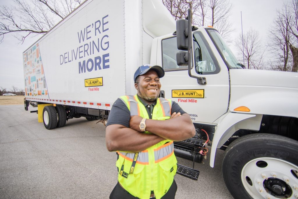 Salomon standing in front of box truck with arms crossed and smiling.