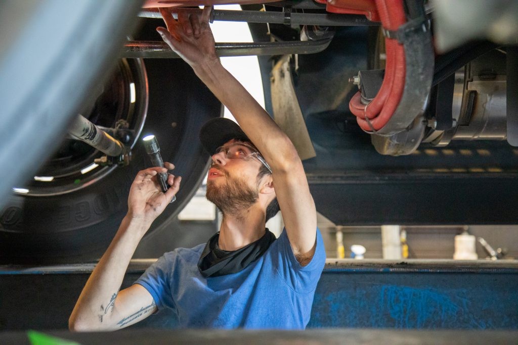 J.B. Hunt technician working on equipment.
