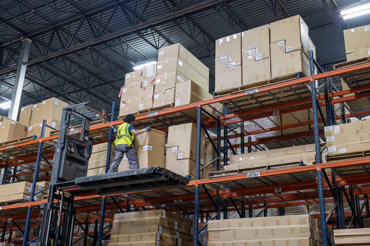 J.B. Hunt warehouse employee on a piece of equipment.