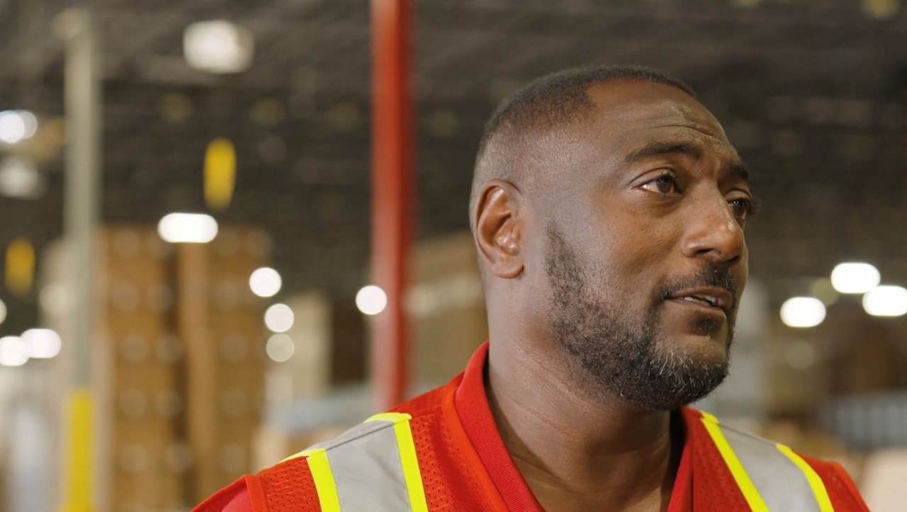 Michael looking off camera and into the warehouse.