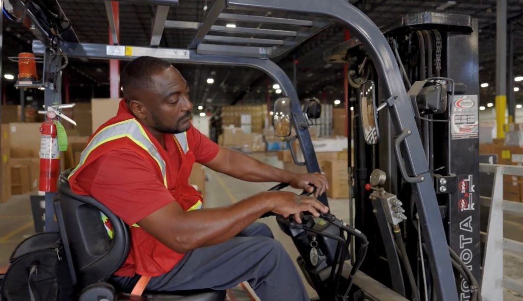 J.B. Hunt warehouse lead operating a forklift.