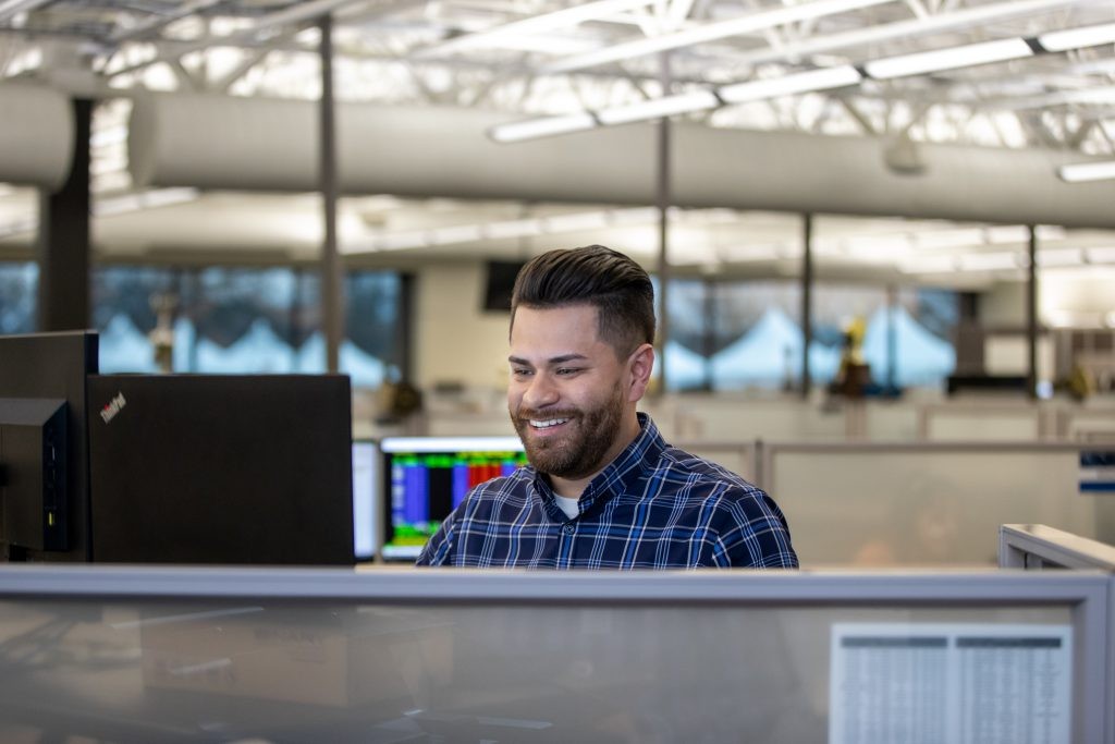 Brokerage employee works at a desk in the J.B. Hunt corporate office.