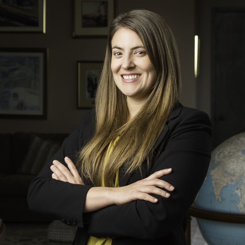 J.B. Hunt Sales Executive April smiles with her hands crossed.