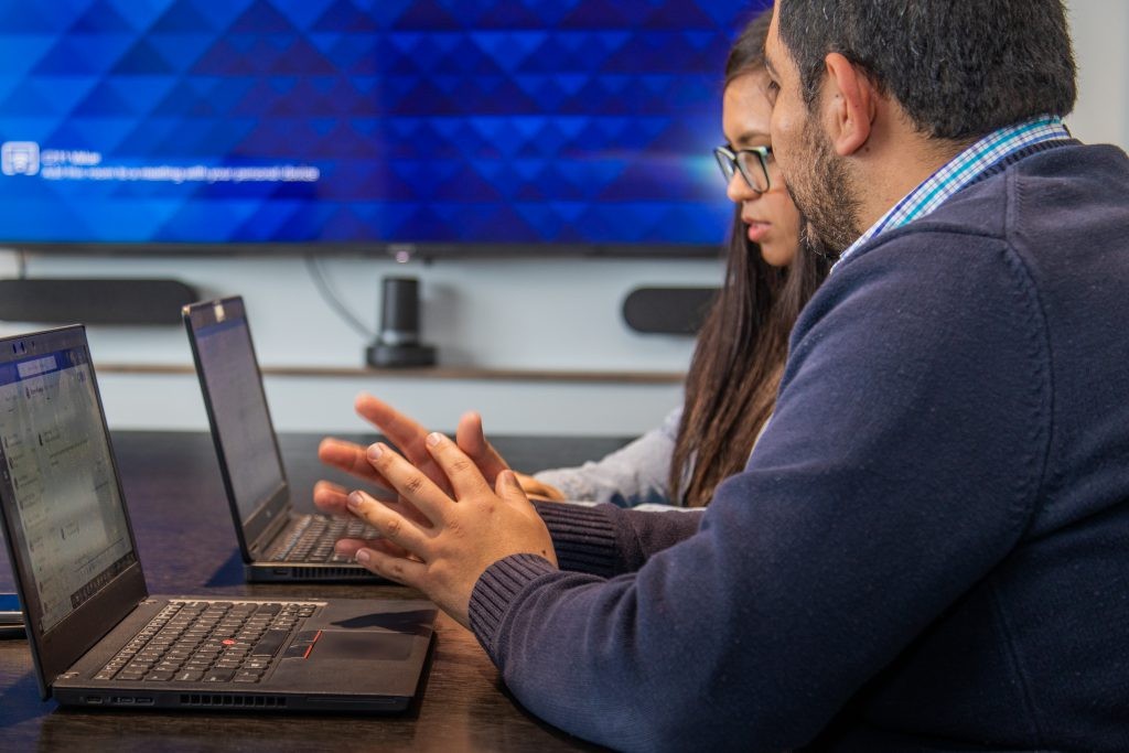Two J.B. Hunt employees working on their laptops