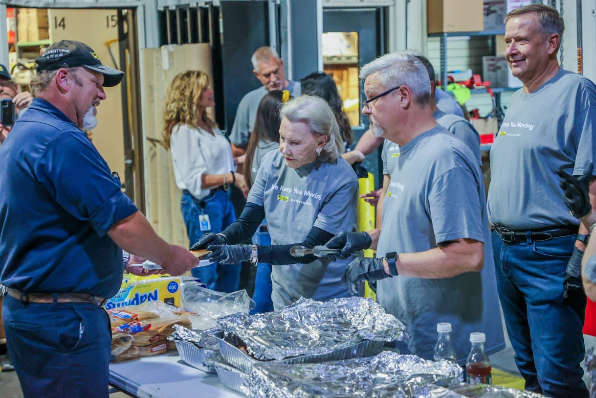 Mrs. Hunt helping serve food to J.B. Hunt employees.