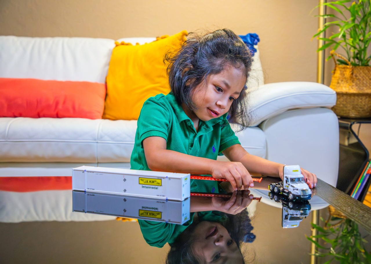 Child playing with a J.B. Hunt model truck.