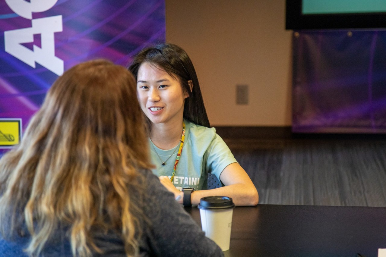 Two employees at a speed networking event.