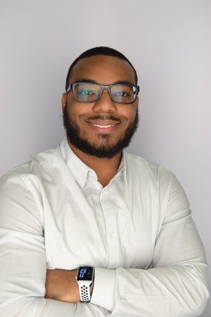 J.B. Hunt sales executive, Montez standing in front of a white background.