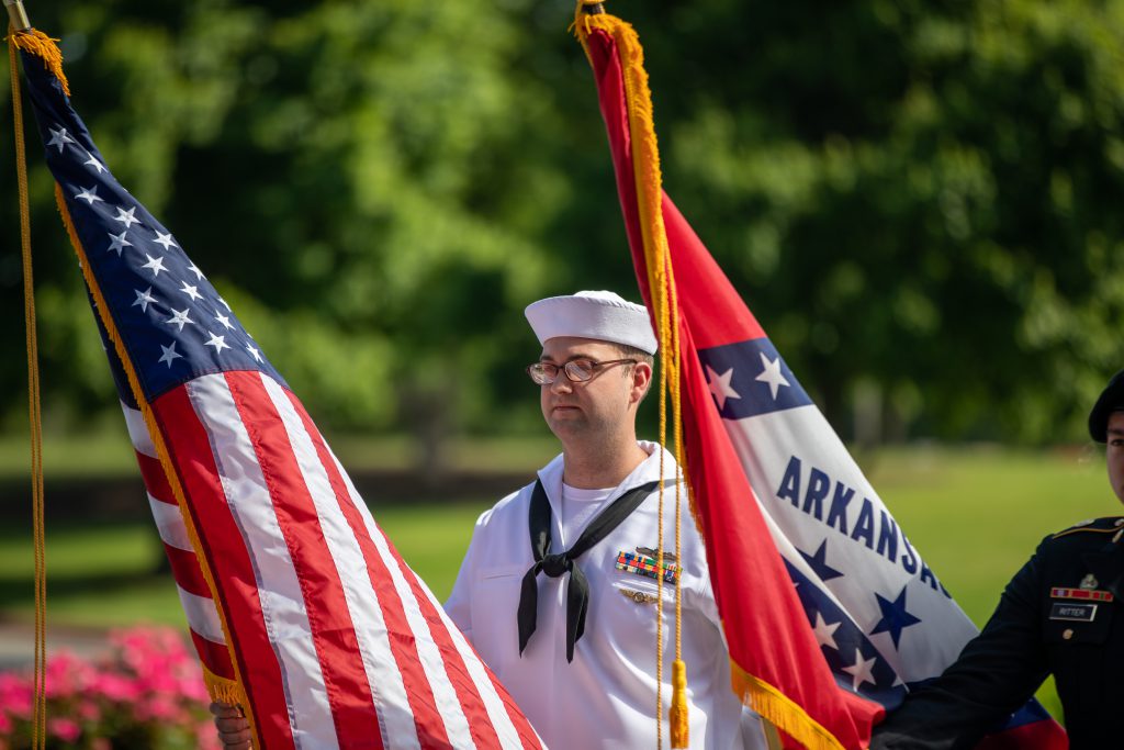 J.B. Hunt military employee holds flag.