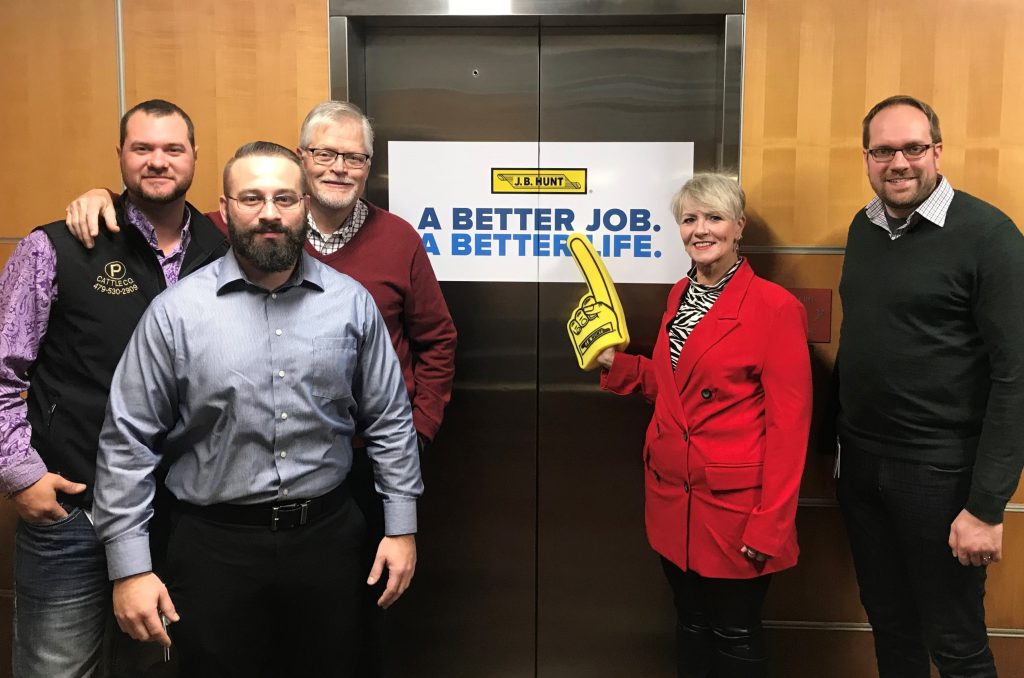 CDP employees pose by "Better Job, Better Life" sign.