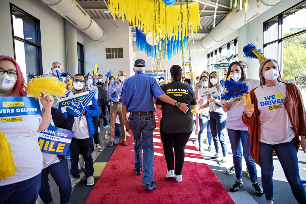 J.B. Hunt employees cheer Million Mile driver and his wife during the Walk of Fame.