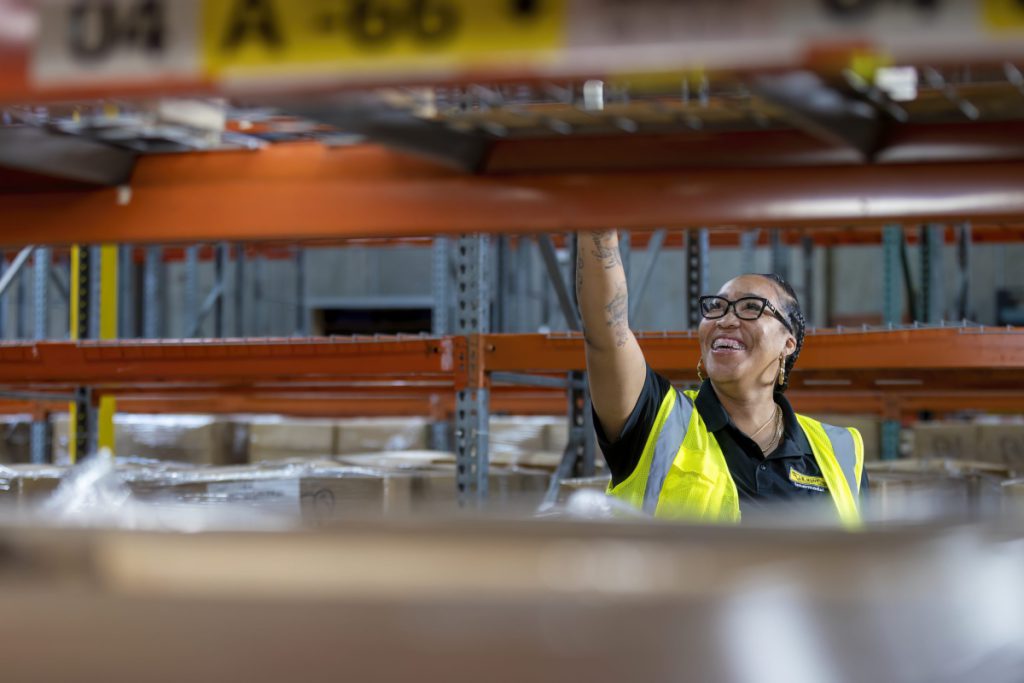 J.B. Hunt warehouse employee picks order from shelves