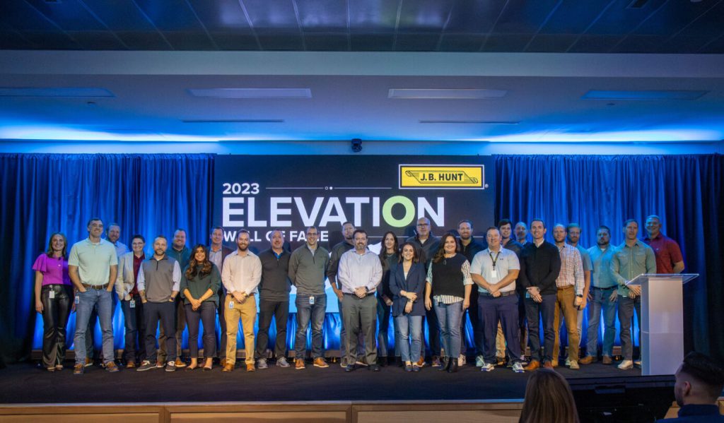 The J.B. Hunt elevation wall of fame event with employees on stage