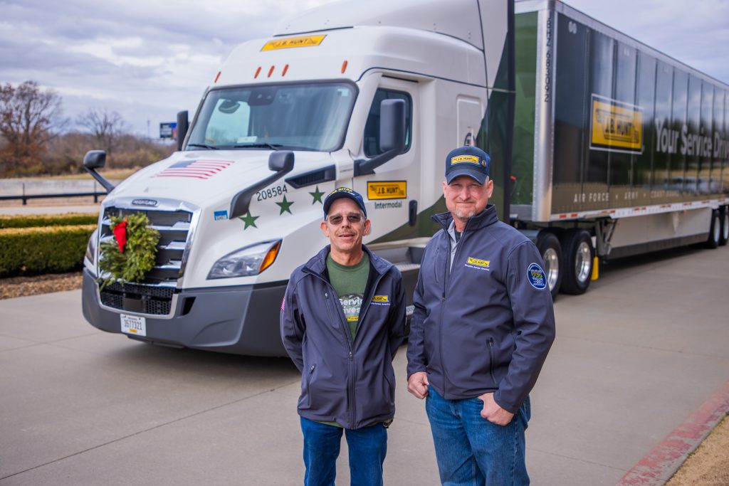 J.B. Hunt drivers posing in front of the 2023 Wreaths Across America truck at corporate headquarters.