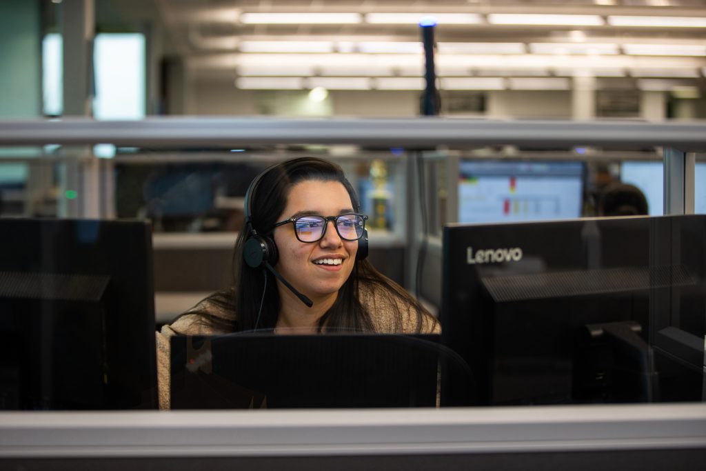 J.B. Hunt employee taking a call at her desk at J.B. Hunt corporate headquarters.