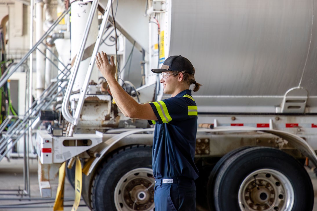 maintenance technician directing truck