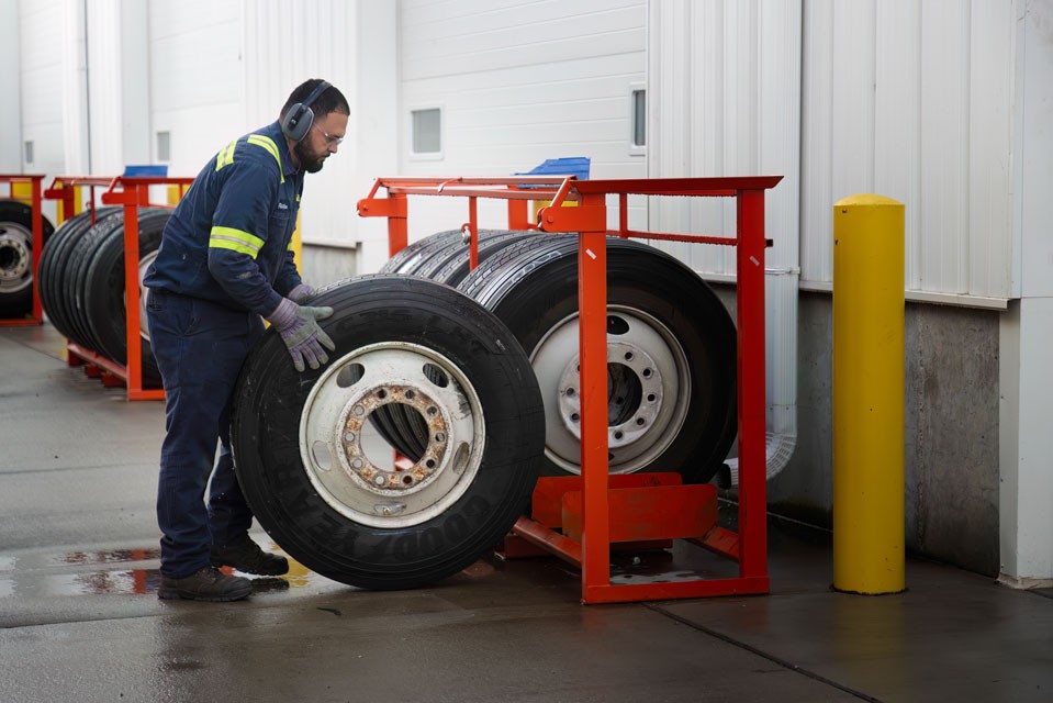 maintenance worker rolling wheel to rack
