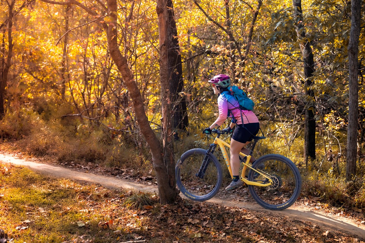employee riding a mountain bike on a trail