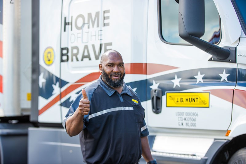 veteran driver standing in front of truck